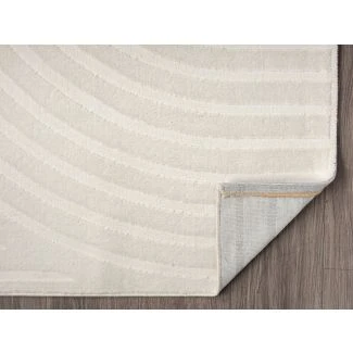 Dette produkt hedder Bella Zen, fremstillet af Polyester & Polypropylen materiale med en smuk Offwhite farve - SE Mattor